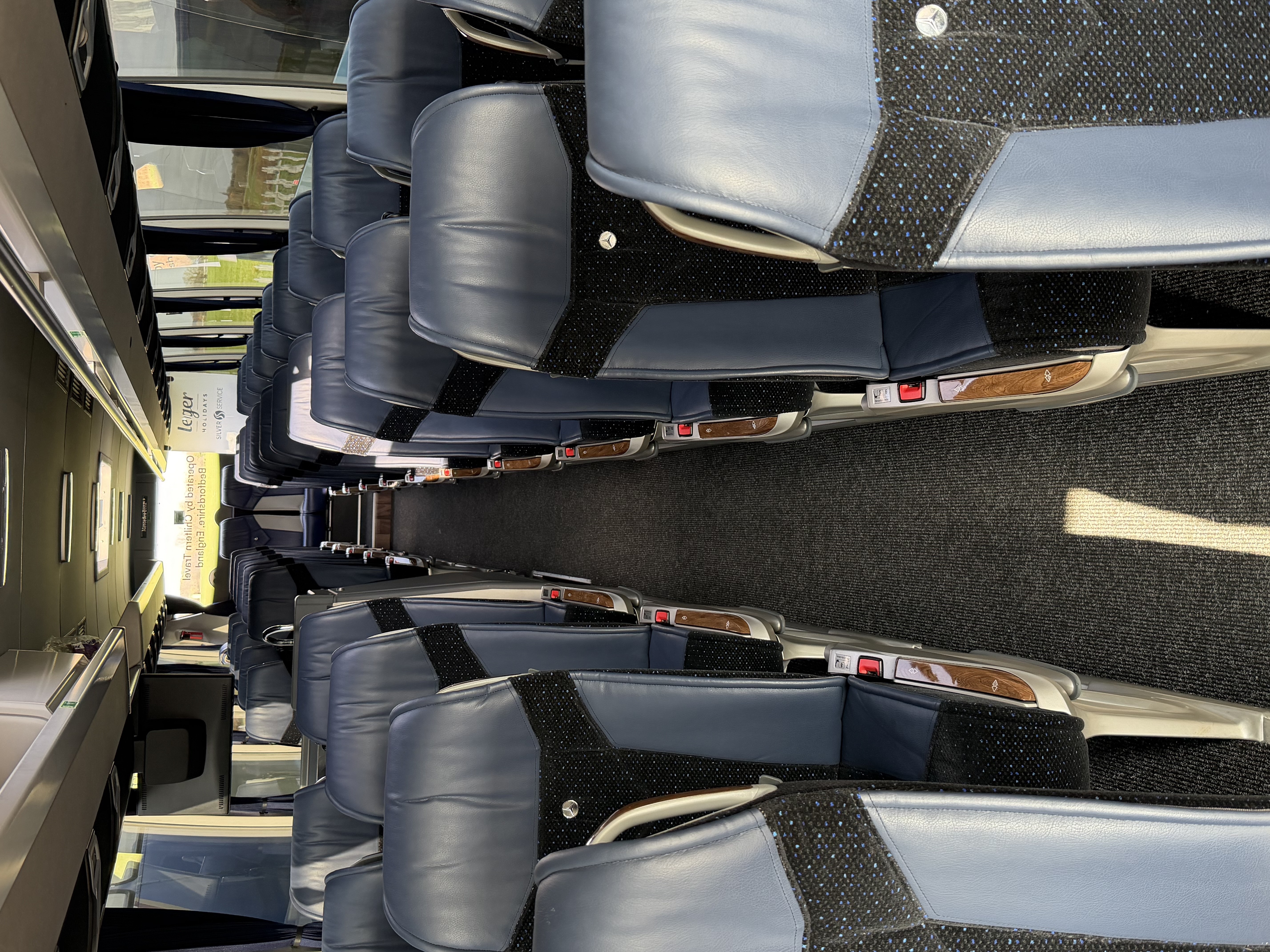 Leather coach seating with wood trim